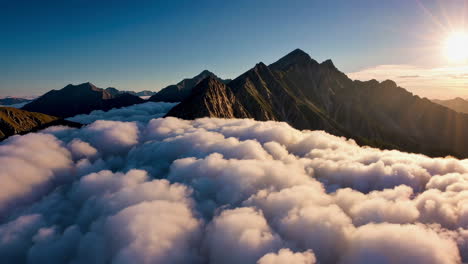 majestic mountain peaks above a sea of clouds at sunrise