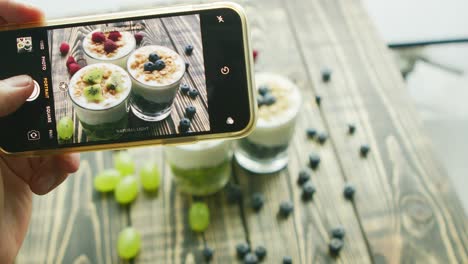 Crop-hand-taking-photo-of-fresh-desserts