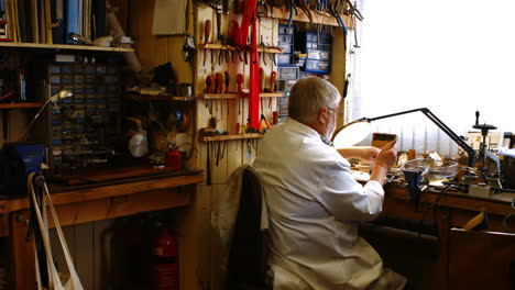 rear view of horologist repairing a watch