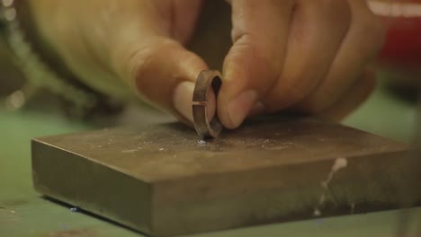 italian goldsmith at work building an engagement or a wedding ring