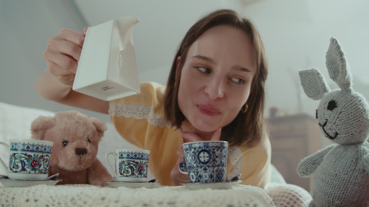 A girl playing with dolls in her room