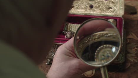 an older man evaluates antique box