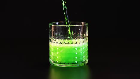 green drink poured, fizzing in a glass