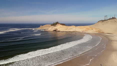 coastal beach scenery with waves and cliffs