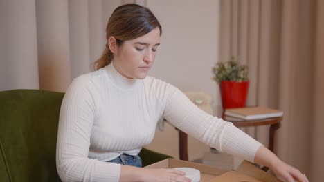 woman unboxing a product at home