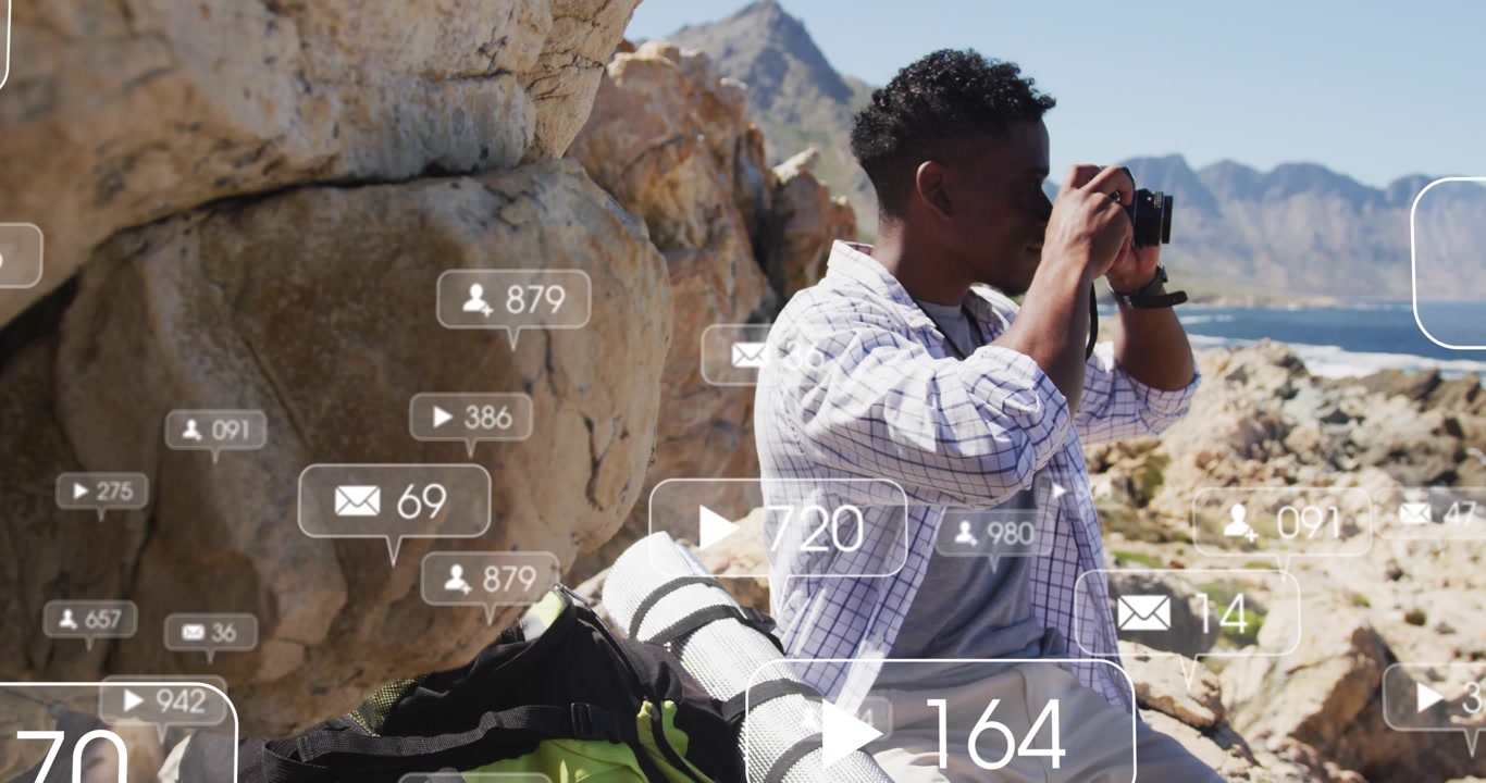 Male shooter on rock seeing social icons floating and shooting views, metrics rising