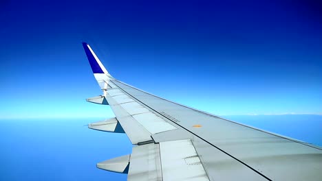 beautiful dramatic blue sky , view from commercial airplane cabin windows