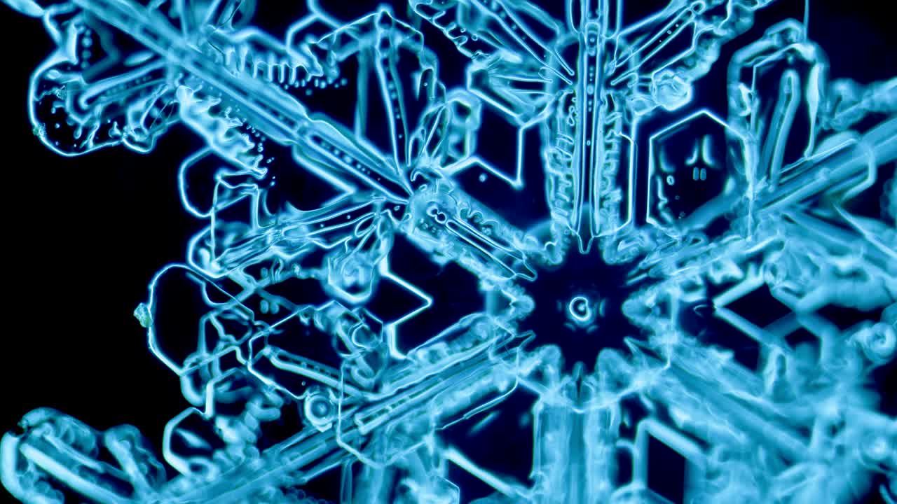 Blue snowflake ice crystal under microscope darkfield
