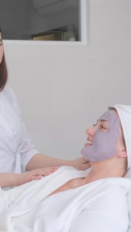 a calm and serene woman is enjoying a rejuvenating professional facial treatment at a modern spa setting