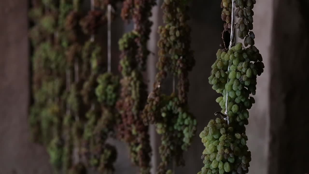 Grape clusters and raisin making in a very old room