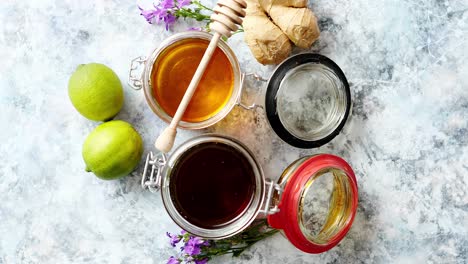 Healthy-food-table-with-different-kinds-of-honey--fresh-ginger-and-lime