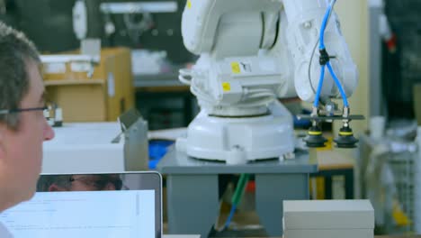 robotic engineer examine robotic machine in warehouse 4k