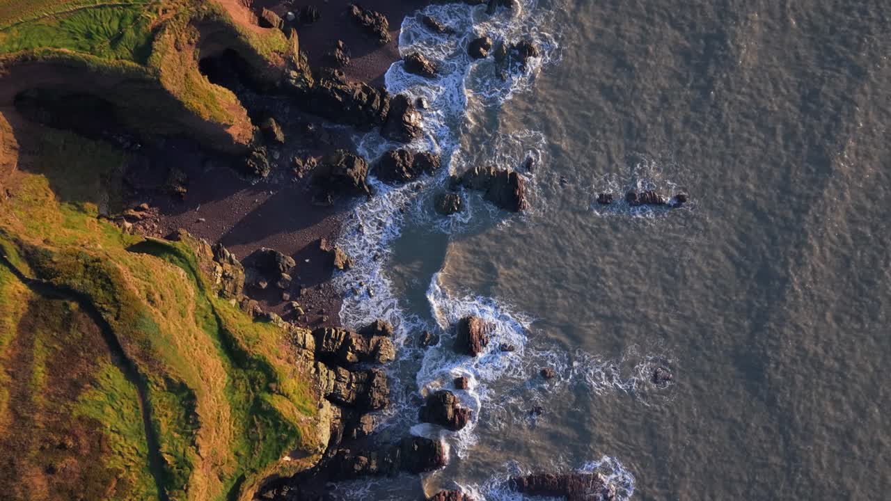 Waves Crashing On The Rocky Coast Of Ireland In The Early Morning. - aerial overhead shot
