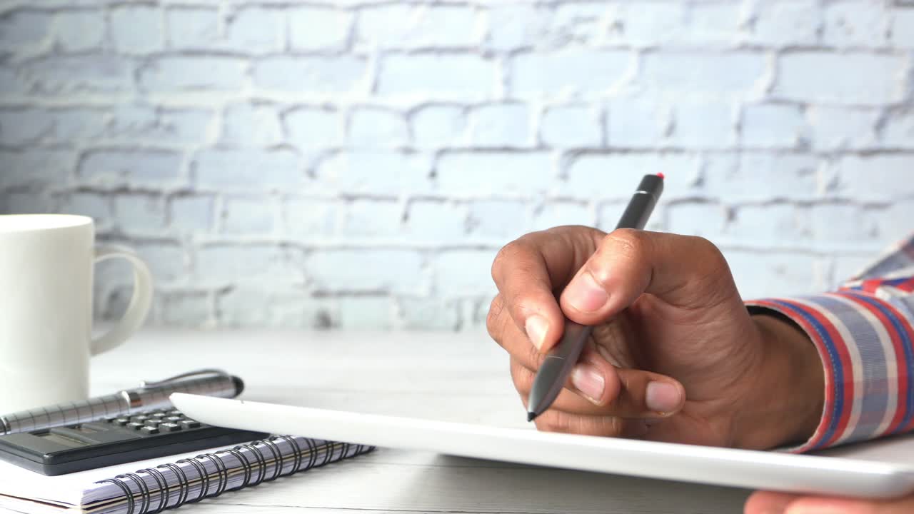 Person using a stylus on a tablet
