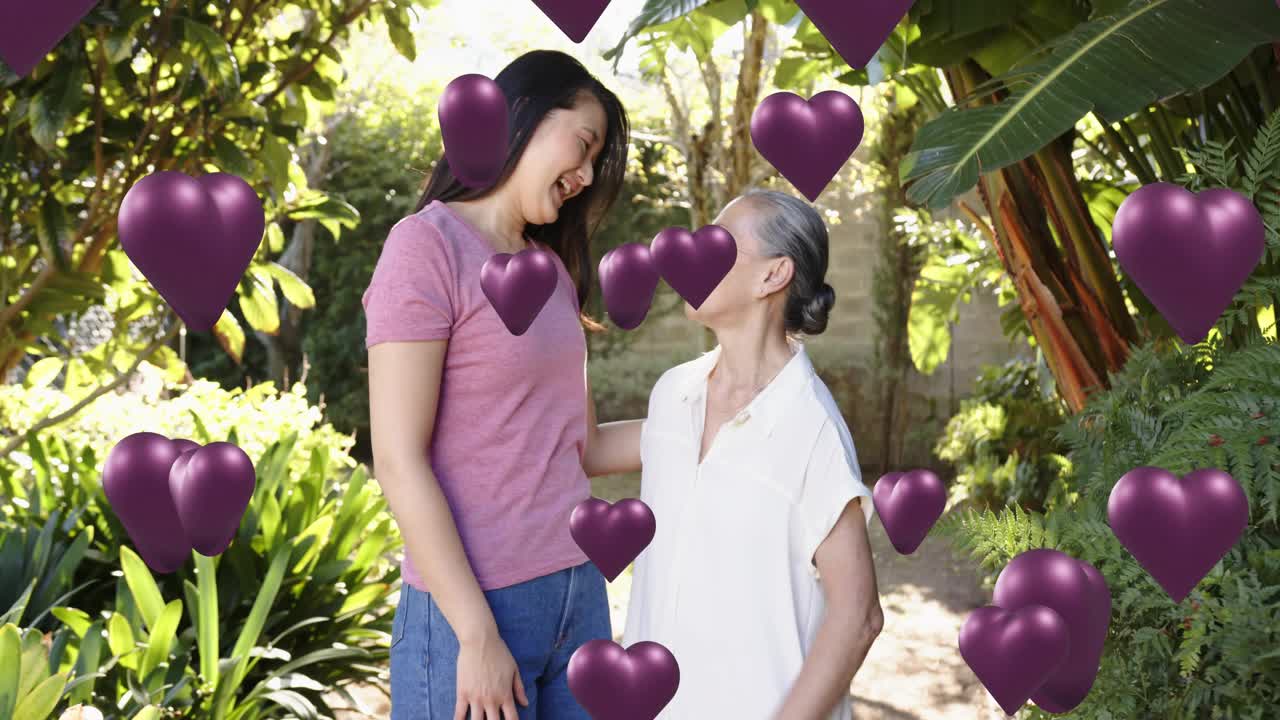 Daughter leaning, flexing, mom touching in yard, purple hearts appearing around them celebrating