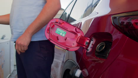 man fueling his car with gasoline