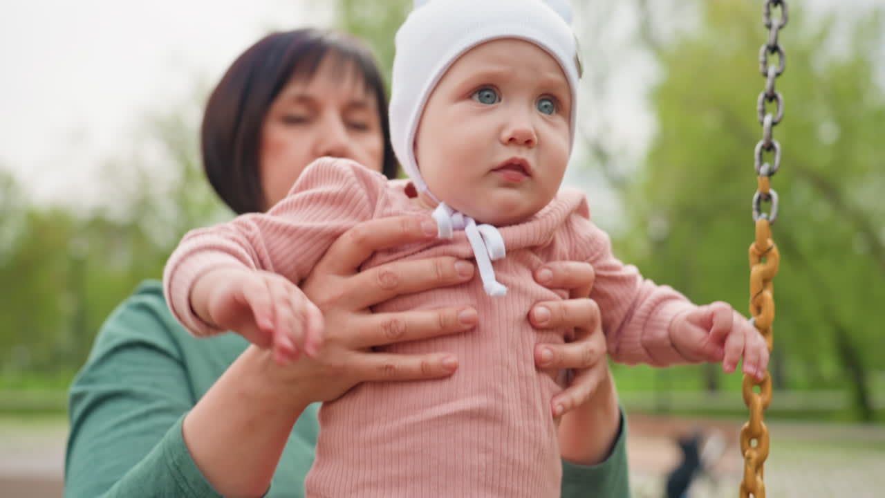 Child Learning To Stand, Young Child Standing Supported By Nanny Outdoors, Child Developing Standing Skills With Nurturing Caregiver Amidst Scenic Park Background And Cheerful Atmosphere