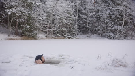 A-cool-looking-hipster-man-relaxes-in-his-ice-hole-profile-to-camera