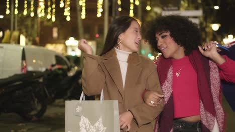 two stylish women shopping at night