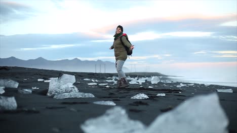 happy girl spinning around in an icelandic landscape