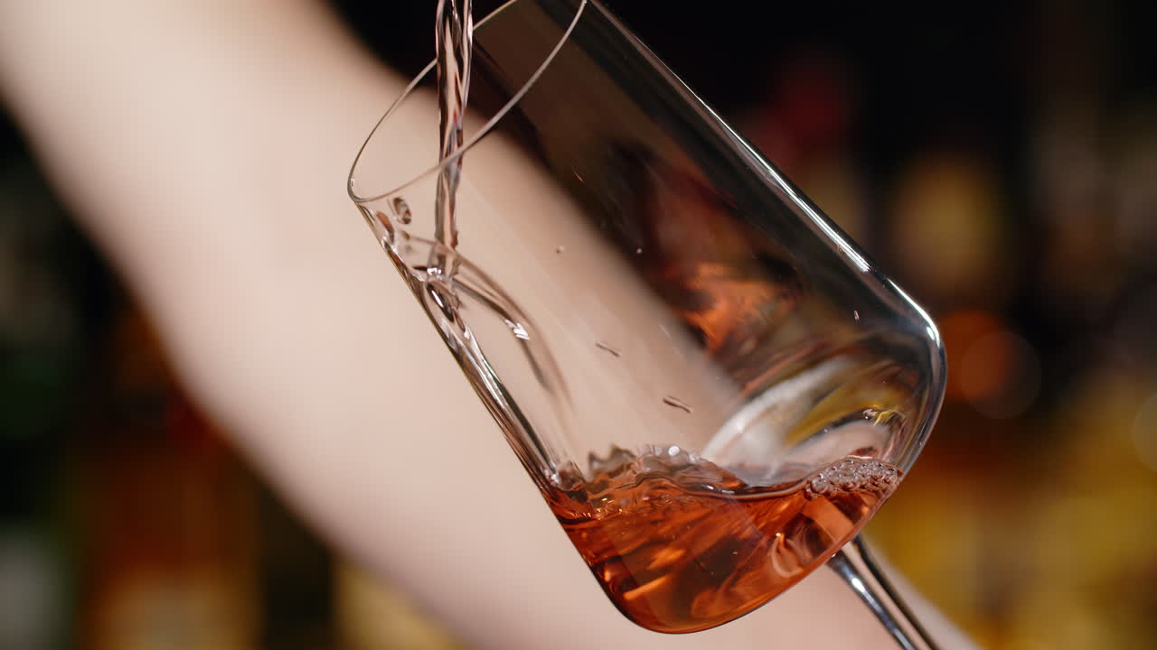 Pouring Rose Wine into a Wine Glass