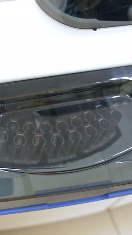 transparent lid at the apparatus for blood testing. a set of test tubes moving inside the equipment. innovative science laboratory technics. vertical video
