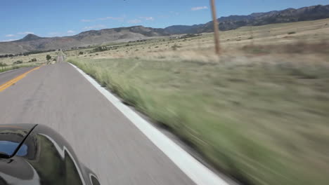 a car driving down a country road  pov