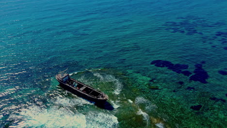 Amidst-the-vast-expanse-of-the-crystal-clear-ocean,-a-multitude-of-age-old-Moroccan-boat-have-been-discovered,-beautifully-preserved