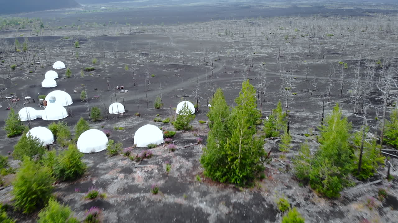 Volcanic Landscape with Dome Structures and Sparse Vegetation