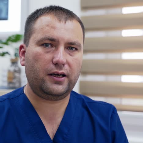 male therapist consulting patients. portrait of a doctor talking on camera in medical center. physician consulting patients via distance video chat. e-health concept.