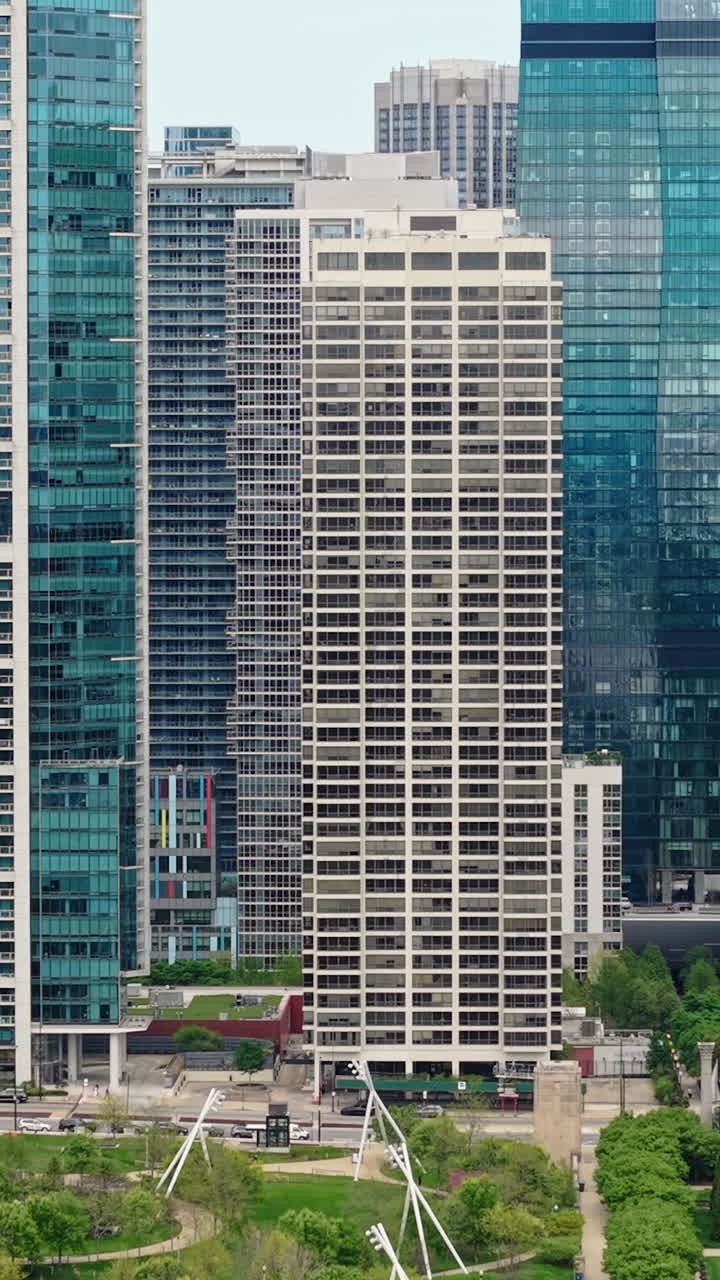 Chicago USA, Vertical Drone Shot of Millennium Park, Skyscrapers and Towers in New Eastside Downtown District