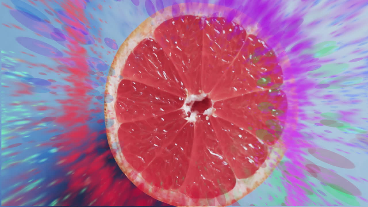 composición de pomelo dividido en dos y manchas de luz sobre fondo rojo