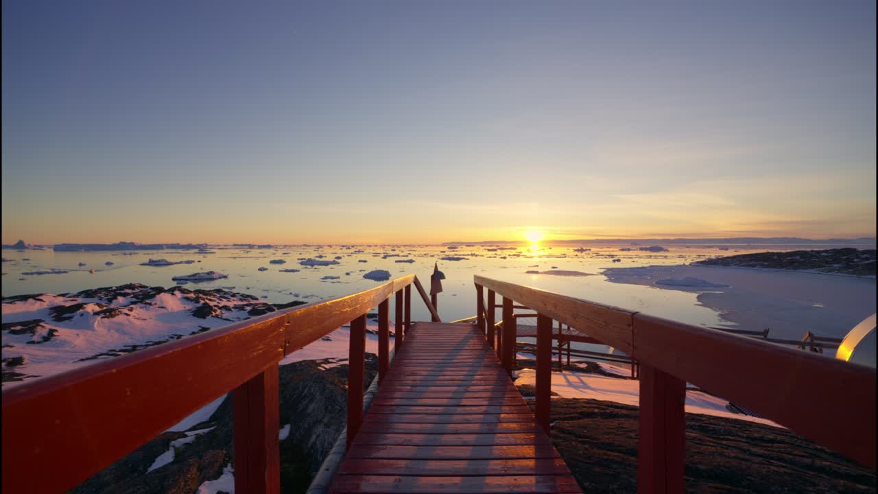 View Over Walkway Towards Sunset Over Sea Of Ilulissat Icefjord