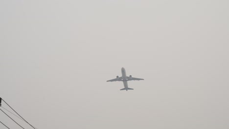 gray city smog overhead with airplane going by in chiang mai thailand