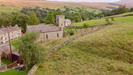 drone aerial reveal shot of church in yorkshire dales