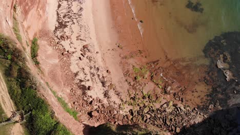 Aerial-Top-Down-Empty-Beach-Beside-Coastal-Cliffs-Near-Ladram-Bay