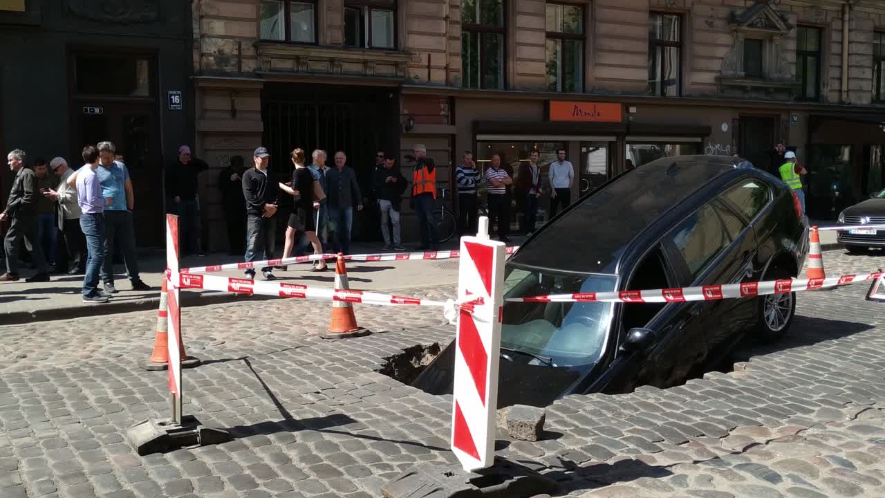 Weak road infrastructure car sinked in a street accident in Riga Latvia