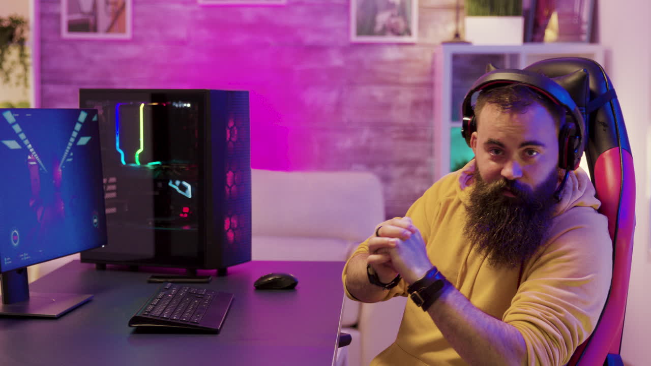 A gamer playing a video game on his computer