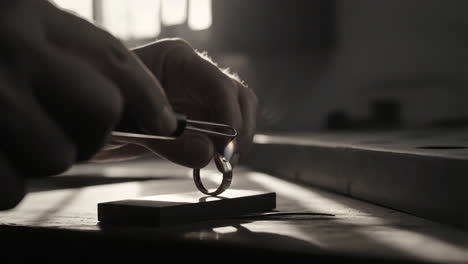 Jeweler soldering a ring with a torch