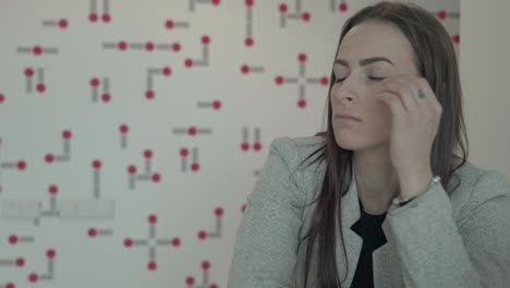 stressed young woman having headache during business hours in office, close up