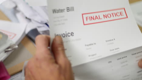 close up of a man opening debt letters