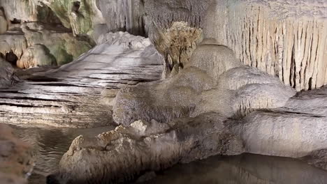 giant limestone underground cave with pure white stalactites and stalagmites