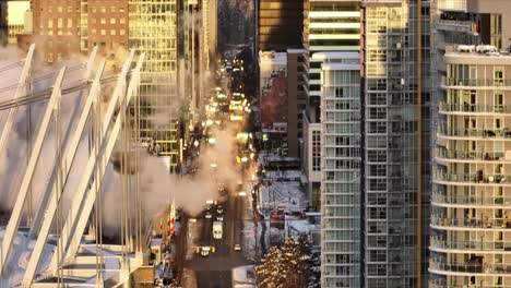 Close-Up-Zoom-Vancouver-Stadium-Downdtown-drone-aerial-view-with-busy-traffic-and-blowing-smoke