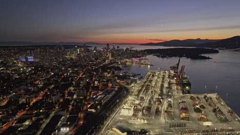 Vancouver-BC-Canada-Aerial-v71-drone-flyover-Centerm-shipyard-capturing-Eastside-neighborhood-and-Gastown-downtown-cityscape-against-sunset-dusk-sky---Shot-with-Mavic-3-Pro-Cine---July-2023