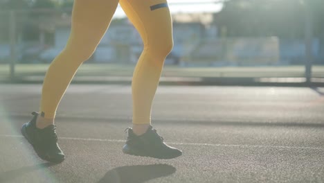 female athlete running on outdoor track in sportswear