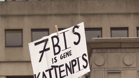 a protest cardboard raised in the air for an adjustment of the climate law, article 7 bis