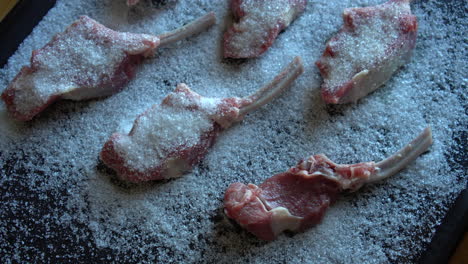 dry ageing meat, chef preparing lamb chops for dry aging, salting process