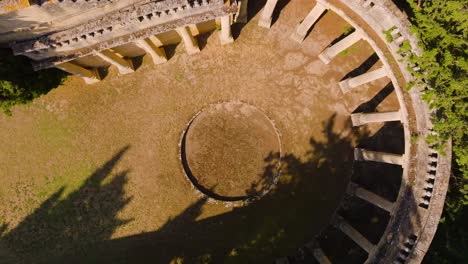 Aerial-rising-shot-of-roman-inspired-column-archway-in-the-garden-of-Chateau-de-Castille