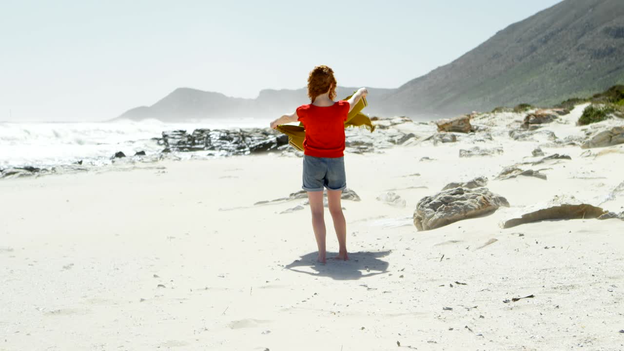 Carefree woman holding shawl against the breeze 4k
