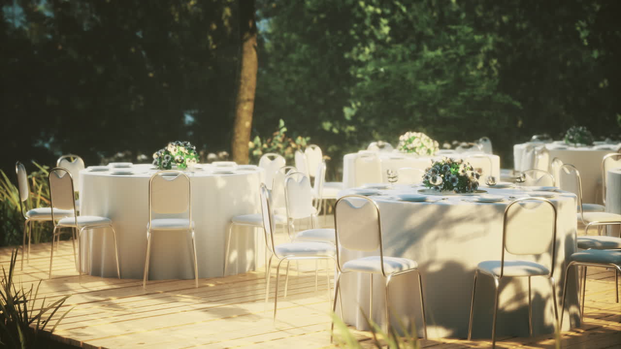 Elegant outdoor wedding setup featuring white tables and floral arrangements